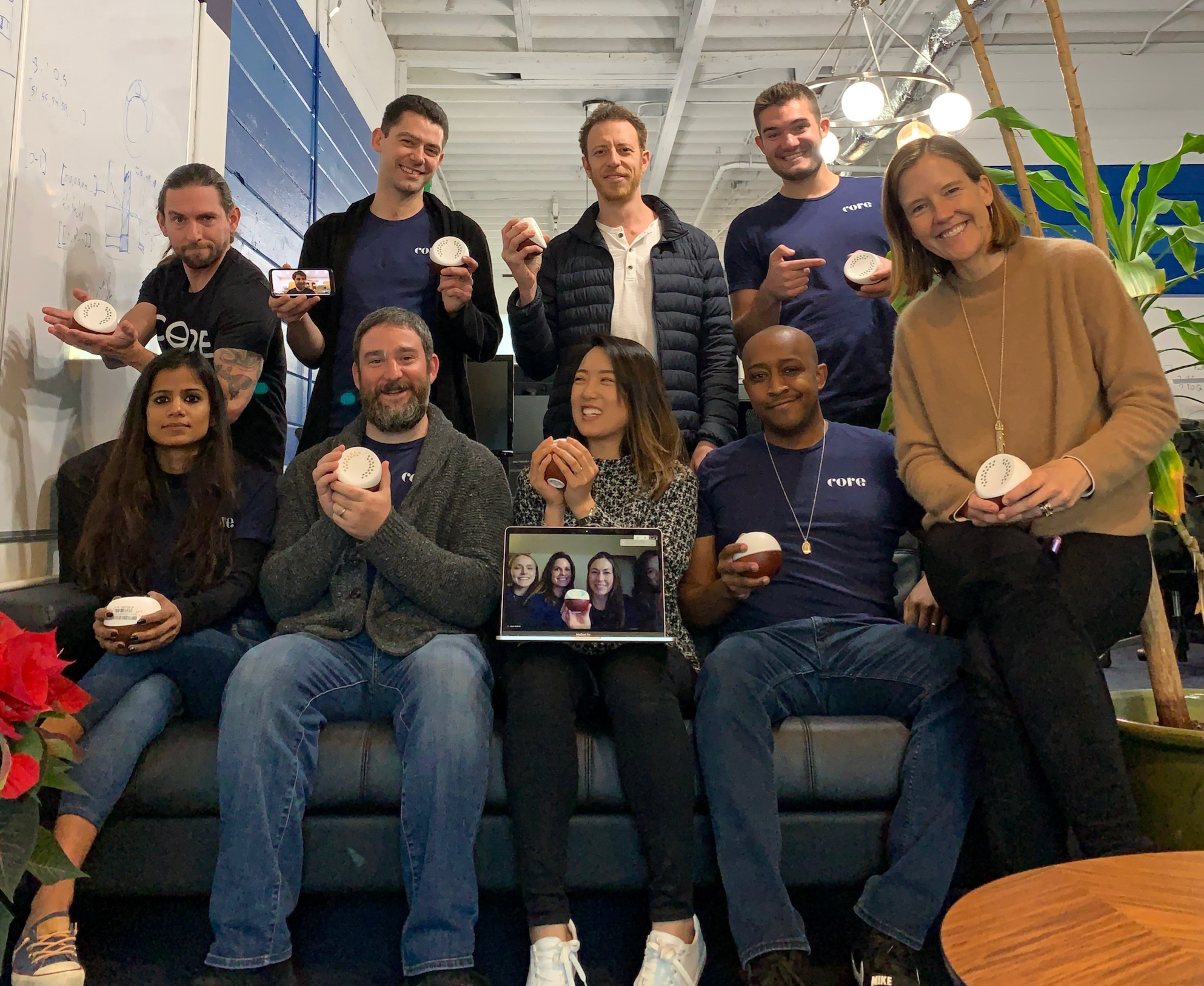 Image of the Core team all proudly holding the first version of the Core product.